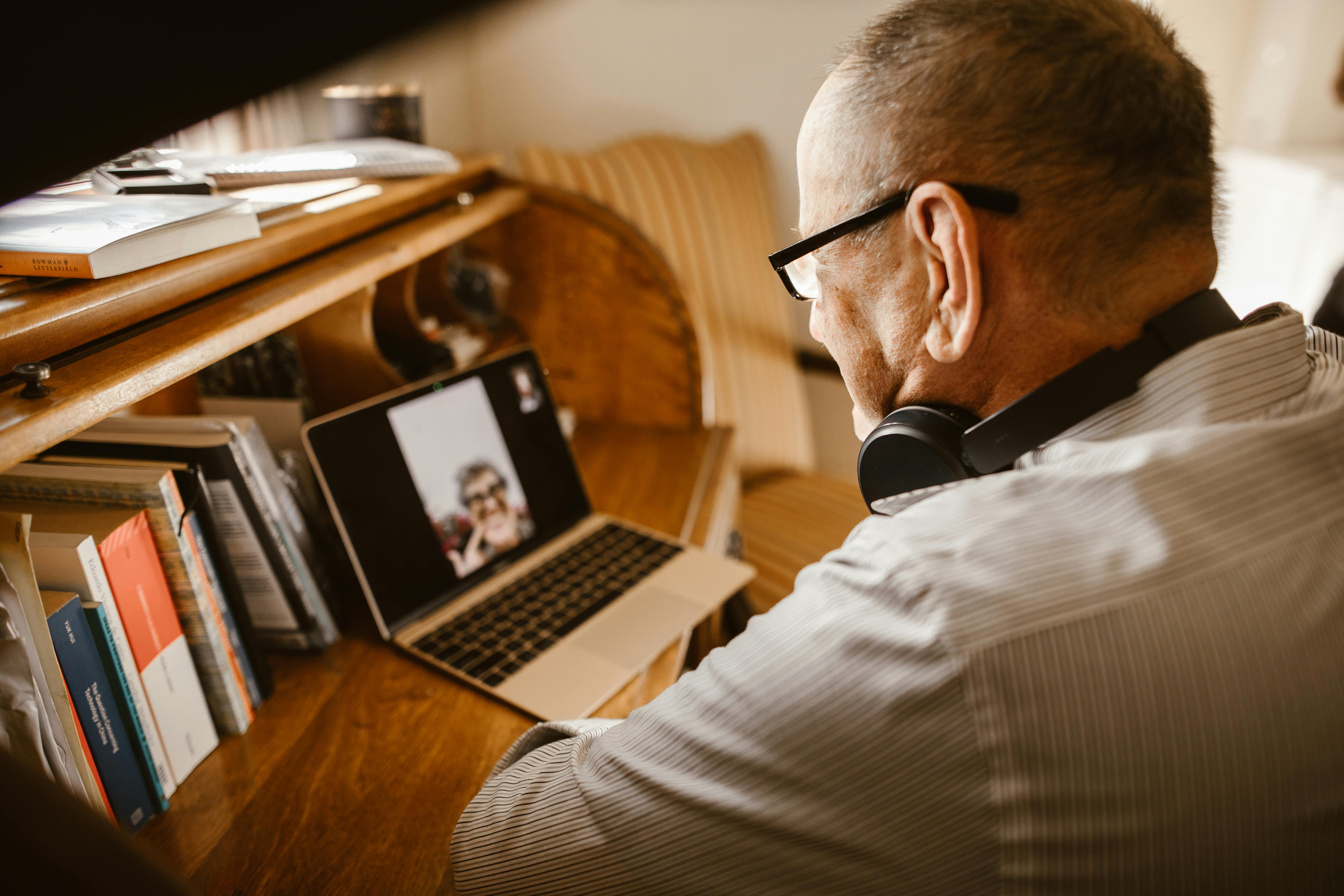 A senior man on a video call from home.